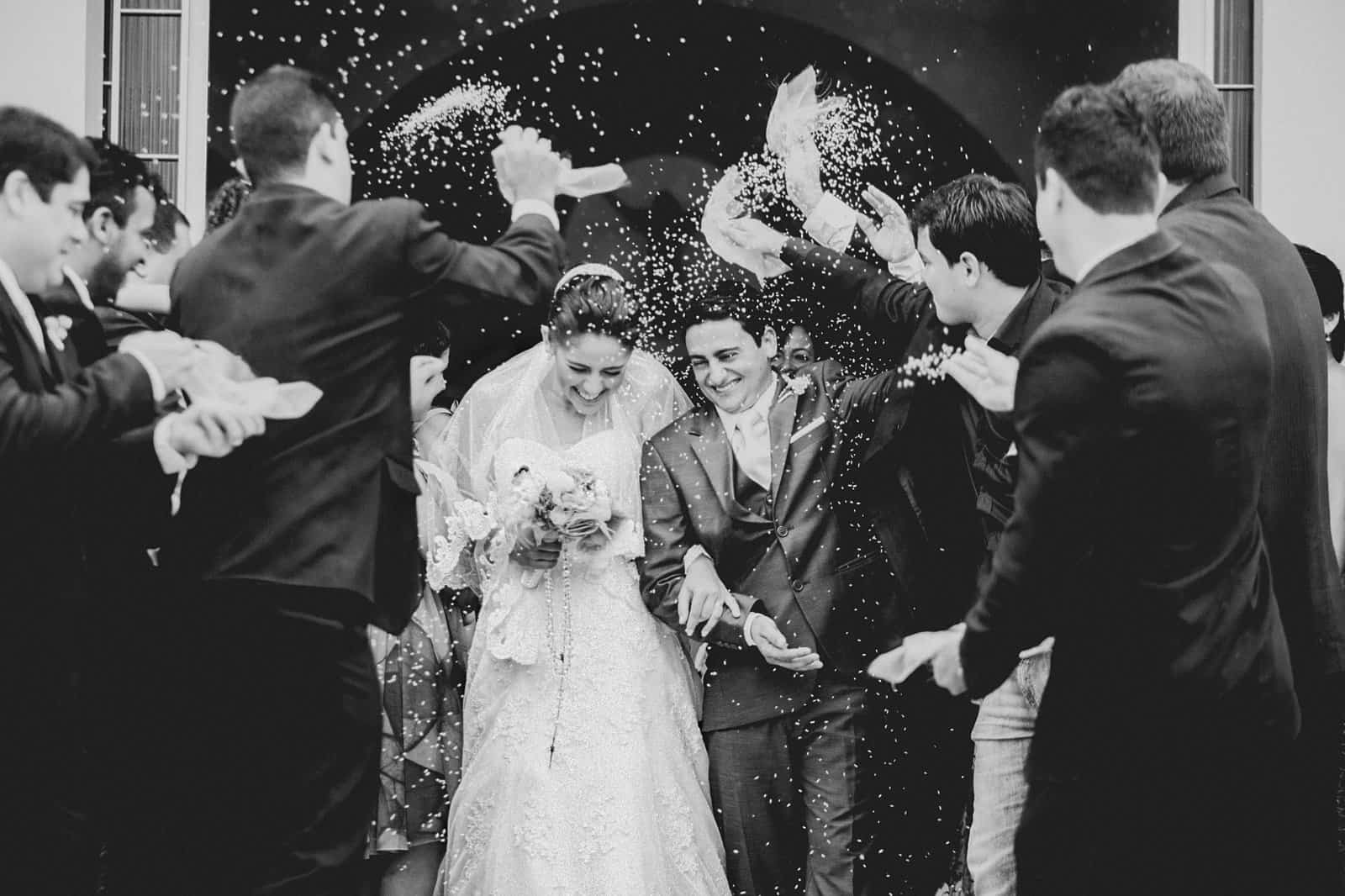 Celebration of love with guests throwing confetti at a wedding ceremony.